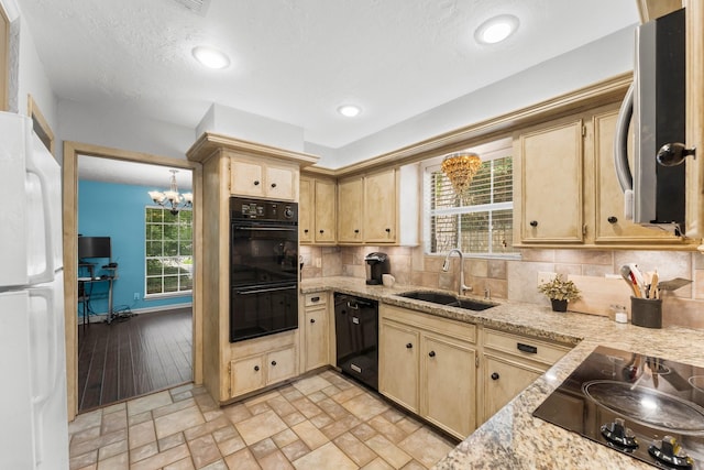 27277 Wells Ln, Conroe, TX 77385 - kitchen with black appliances, light brown cabinetry, tasteful backsplash, plenty of natural light, and recessed lighting