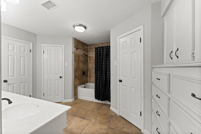 27277 Wells Ln, Conroe, TX 77385 - bathroom with shower / tub combo, double vanity, and a textured ceiling