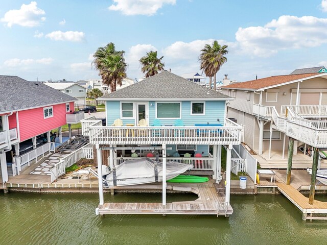 22123 Yoakum Dr, Galveston, TX 77554 - dock featuring stairway, boat lift, and a deck with water view