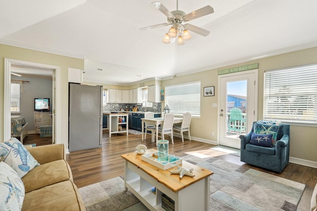 22123 Yoakum Dr, Galveston, TX 77554 - living room featuring ornamental molding, wood finished floors, and a ceiling fan