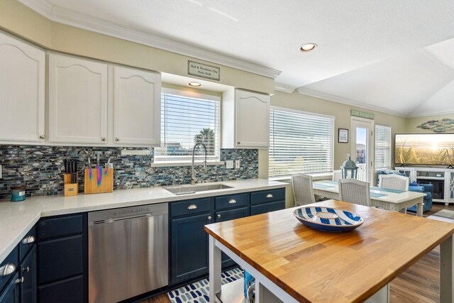 22123 Yoakum Dr, Galveston, TX 77554 - kitchen featuring white cabinetry, stainless steel dishwasher, decorative backsplash, wood finished floors, and ornamental molding