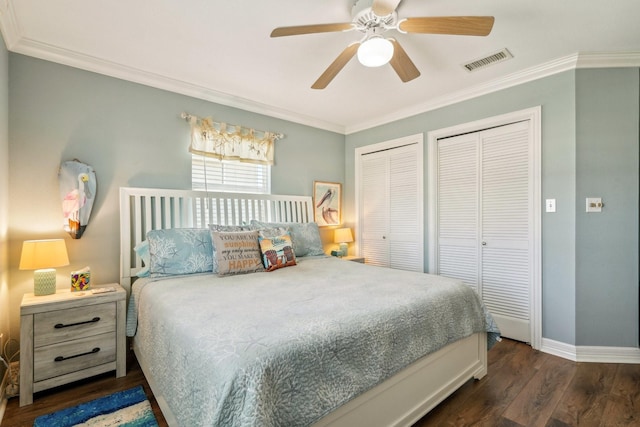 22123 Yoakum Dr, Galveston, TX 77554 - bedroom with two closets, dark wood-type flooring, ornamental molding, and a ceiling fan