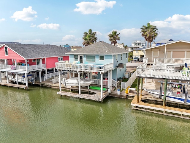 22123 Yoakum Dr, Galveston, TX 77554 - dock area with stairs, boat lift, a residential view, and a deck with water view