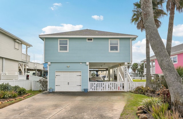 22123 Yoakum Dr, Galveston, TX 77554 - coastal inspired home with a garage, driveway, and a shingled roof