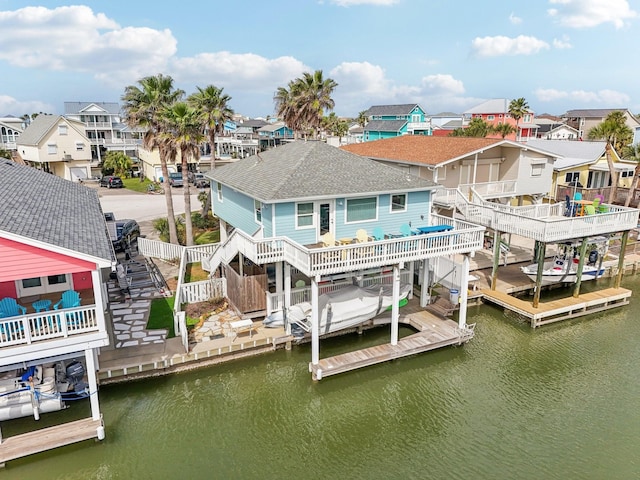 22123 Yoakum Dr, Galveston, TX 77554 - back of property featuring a residential view, stairway, a water view, and roof with shingles