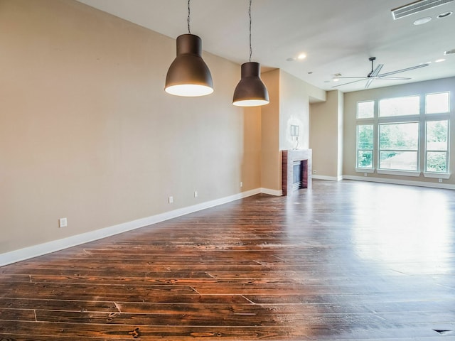 3419 Gillespie St, Houston, TX 77020 - unfurnished living room with dark wood-type flooring, a fireplace, a ceiling fan, and recessed lighting