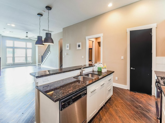 3419 Gillespie St, Houston, TX 77020 - kitchen with stainless steel dishwasher, dark wood-type flooring, an island with sink, ceiling fan, and white cabinetry