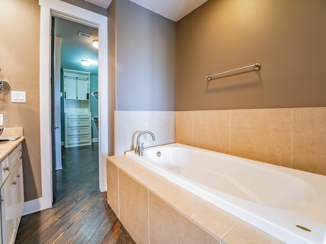 3419 Gillespie St, Houston, TX 77020 - bathroom with vanity, wood finished floors, and a garden tub