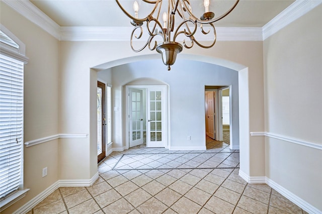 30 N Scribewood Cir, The Woodlands, TX 77382 - unfurnished dining area with arched walkways, a chandelier, light tile patterned floors, and crown molding