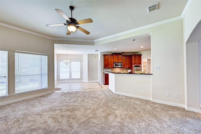 30 N Scribewood Cir, The Woodlands, TX 77382 - unfurnished living room featuring light colored carpet, ceiling fan, crown molding, a chandelier, and arched walkways