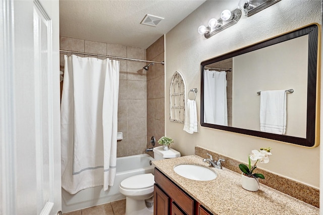 30 N Scribewood Cir, The Woodlands, TX 77382 - bathroom featuring vanity, shower / bath combo with shower curtain, a textured ceiling, and tile patterned flooring