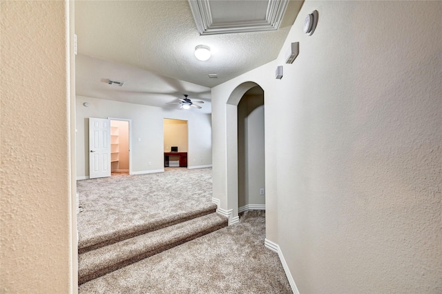30 N Scribewood Cir, The Woodlands, TX 77382 - corridor with carpet flooring, a textured ceiling, arched walkways, and a textured wall