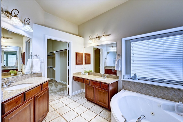 30 N Scribewood Cir, The Woodlands, TX 77382 - bathroom featuring a tub with jets, two vanities, tile patterned flooring, and lofted ceiling