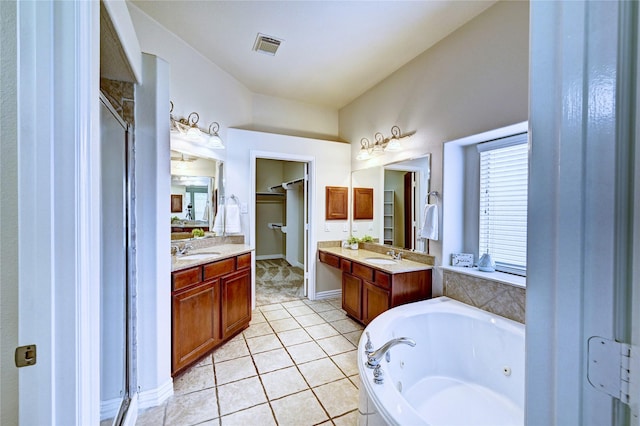 30 N Scribewood Cir, The Woodlands, TX 77382 - bathroom with a tub with jets, vanity, tile patterned flooring, a spacious closet, and lofted ceiling