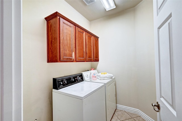 30 N Scribewood Cir, The Woodlands, TX 77382 - laundry area featuring washer and clothes dryer, cabinet space, and light tile patterned flooring