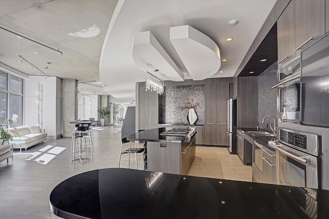 1901 Post Oak Blvd Unit 3101, Houston, TX 77056 - kitchen with appliances with stainless steel finishes, modern cabinets, a kitchen island, and dark countertops