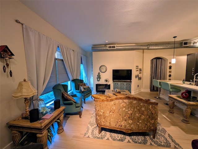 1901 Post Oak Blvd Unit 3101, Houston, TX 77056 - living room with wood finished floors and arched walkways