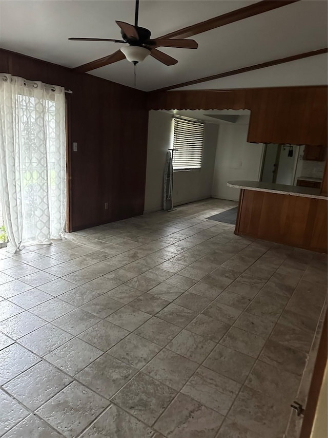 6646 Bayou View Dr, Houston, TX 77091 - unfurnished living room featuring a ceiling fan, vaulted ceiling, and light stone finish flooring