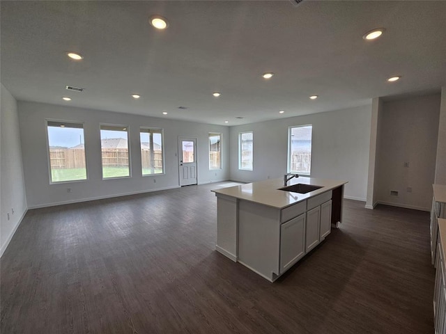 3055 Ruby Ridge Dr, Katy, TX 77493 - kitchen with dark wood-style floors, recessed lighting, open floor plan, light countertops, and a center island with sink
