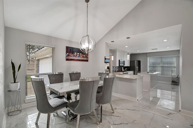16806 Carbridge Dr, Houston, TX 77084 - dining area featuring a chandelier, light marble finish floors, lofted ceiling, and recessed lighting