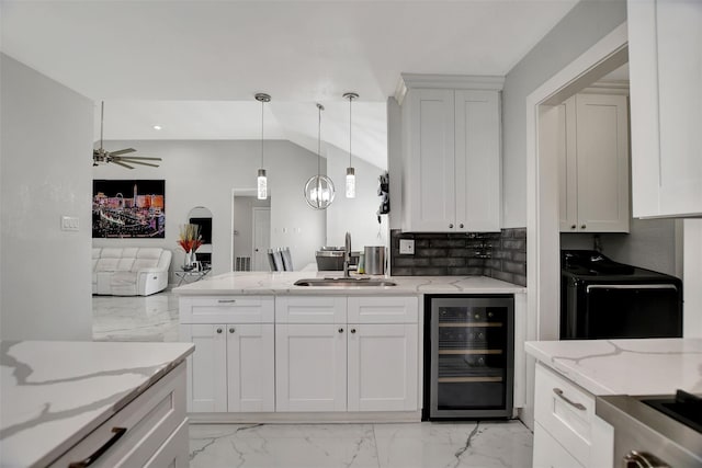 16806 Carbridge Dr, Houston, TX 77084 - kitchen featuring beverage cooler, white cabinets, light stone countertops, light marble finish floors, and recessed lighting