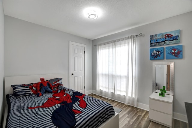 16806 Carbridge Dr, Houston, TX 77084 - bedroom featuring baseboards and light wood-style floors