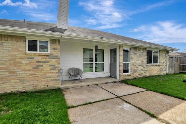16806 Carbridge Dr, Houston, TX 77084 - rear view of house featuring a chimney, brick siding, and a shingled roof