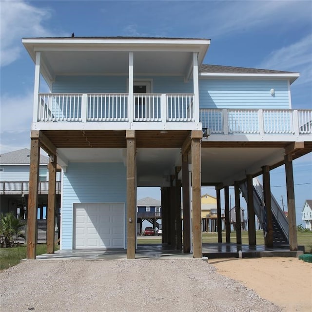 13214 Buccaneer Pkwy, Freeport, TX 77541 - coastal home featuring a carport, a garage, driveway, and stairs