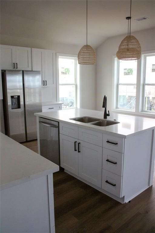 13214 Buccaneer Pkwy, Freeport, TX 77541 - kitchen with appliances with stainless steel finishes, dark wood-style floors, light countertops, and vaulted ceiling
