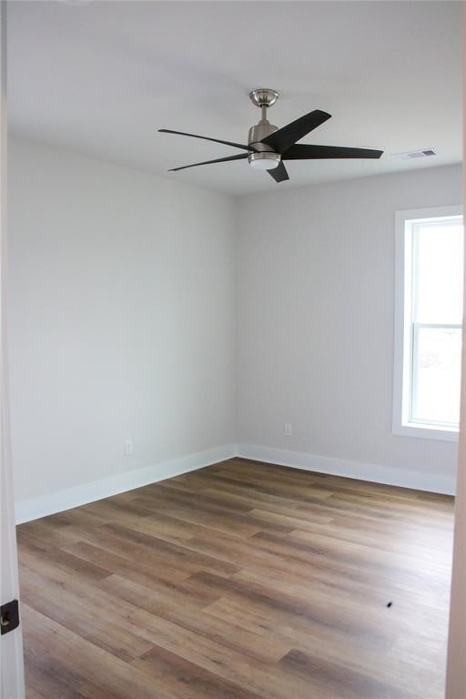 13214 Buccaneer Pkwy, Freeport, TX 77541 - spare room with ceiling fan and wood finished floors