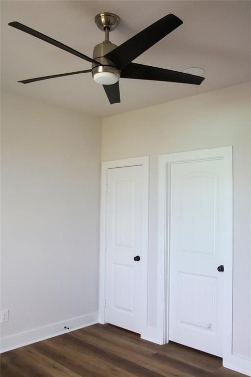 13214 Buccaneer Pkwy, Freeport, TX 77541 - unfurnished bedroom with dark wood-style floors and a ceiling fan