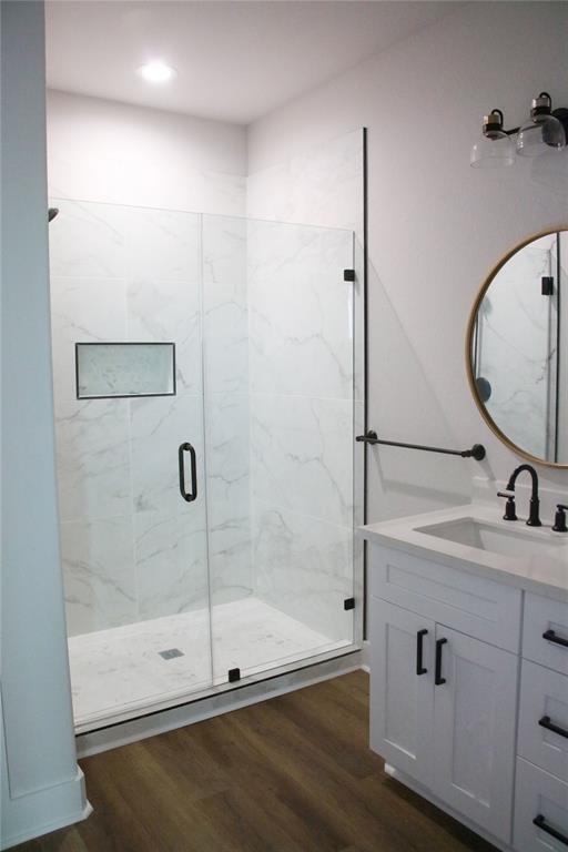 13214 Buccaneer Pkwy, Freeport, TX 77541 - full bathroom featuring vanity, wood finished floors, and a marble finish shower