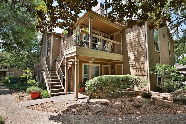 1880 White Oak Dr Unit 159, Houston, TX 77009 - view of front of house with a balcony, stairs, and a chimney