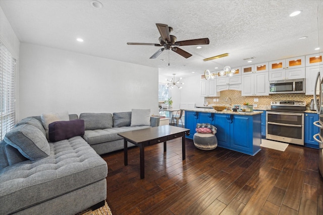 1880 White Oak Dr Unit 159, Houston, TX 77009 - living room with a chandelier, a ceiling fan, dark wood finished floors, and recessed lighting
