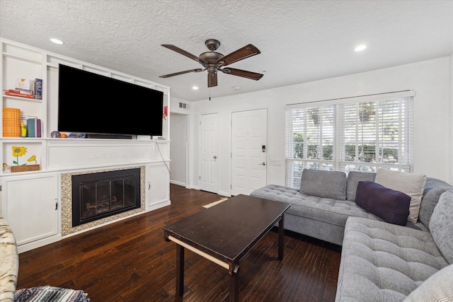 1880 White Oak Dr Unit 159, Houston, TX 77009 - living area featuring a ceiling fan, a glass covered fireplace, dark wood finished floors, recessed lighting, and a textured ceiling