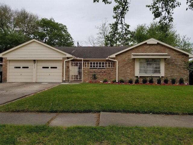 8806 Leader St, Houston, TX 77036 - ranch-style house with brick siding, a garage, concrete driveway, a front lawn, and roof with shingles