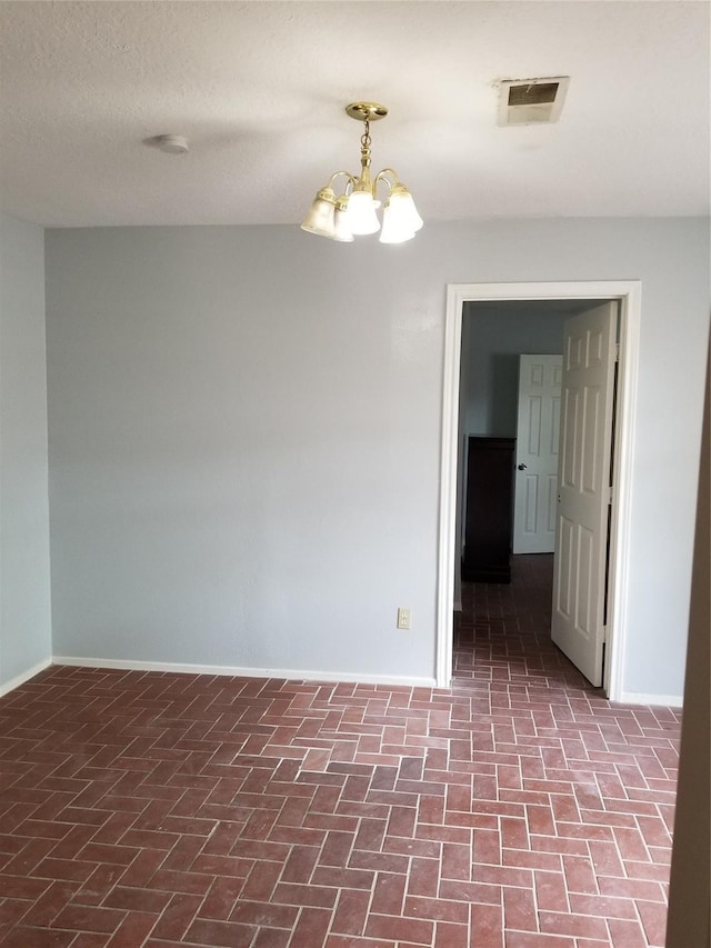 8806 Leader St, Houston, TX 77036 - unfurnished room with a chandelier and brick patterned floors
