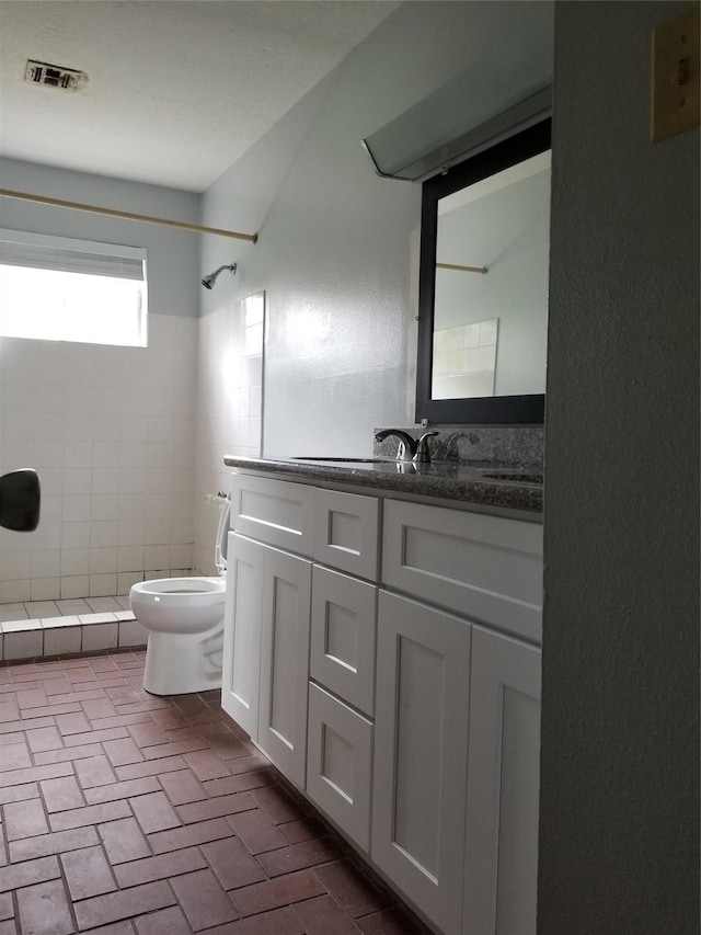 8806 Leader St, Houston, TX 77036 - full bathroom with a tile shower, brick patterned flooring, and vanity