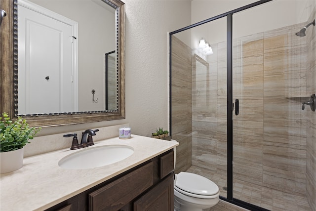 131 Evening Tide Ct, Conroe, TX 77318 - bathroom with vanity, a shower stall, and a textured wall