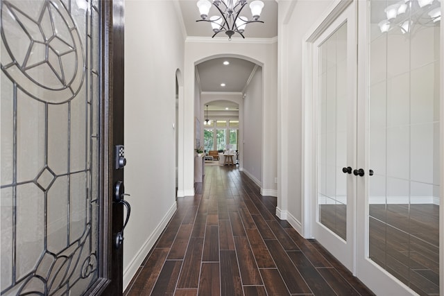 131 Evening Tide Ct, Conroe, TX 77318 - entryway with arched walkways, a chandelier, crown molding, dark wood finished floors, and french doors