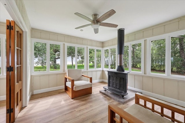 3533 Fm 563, Anahuac, TX 77514 - sunroom / solarium with a wood stove, wood finished floors, a decorative wall, and french doors
