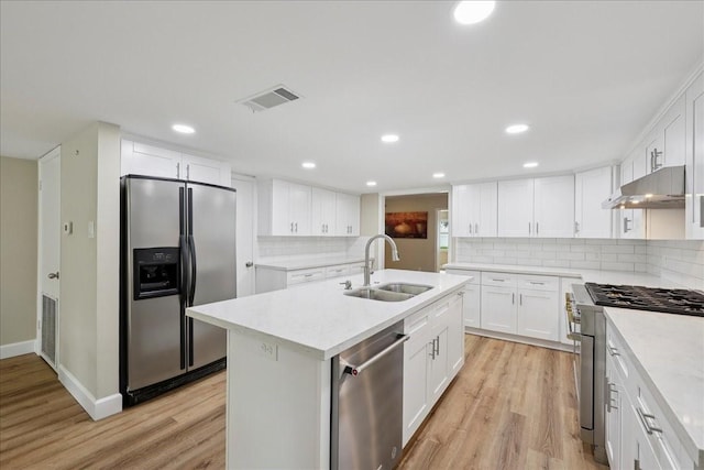 3533 Fm 563, Anahuac, TX 77514 - kitchen featuring appliances with stainless steel finishes, under cabinet range hood, light wood finished floors, light countertops, and recessed lighting
