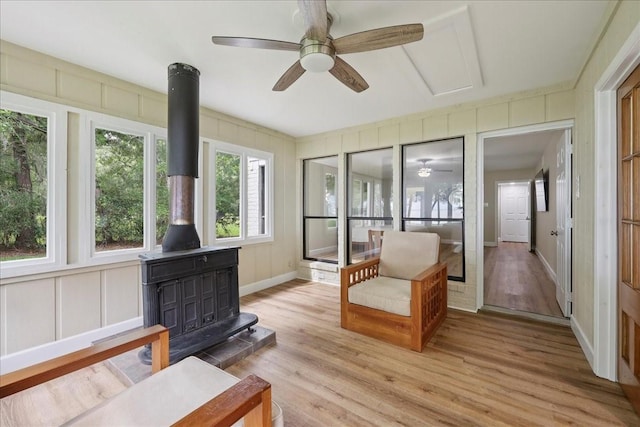 3533 Fm 563, Anahuac, TX 77514 - sunroom / solarium featuring a wood stove, wood finished floors, and a decorative wall
