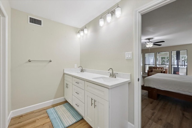 3533 Fm 563, Anahuac, TX 77514 - ensuite bathroom with wood finished floors, double vanity, and a ceiling fan