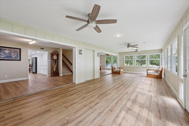 3533 Fm 563, Anahuac, TX 77514 - unfurnished living room featuring light wood-style flooring, ceiling fan, healthy amount of natural light, stairs, and recessed lighting