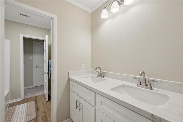 3533 Fm 563, Anahuac, TX 77514 - full bath featuring wood finished floors, double vanity, and crown molding