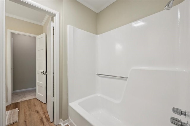 3533 Fm 563, Anahuac, TX 77514 - bathroom featuring wood finished floors, tub / shower combination, and crown molding