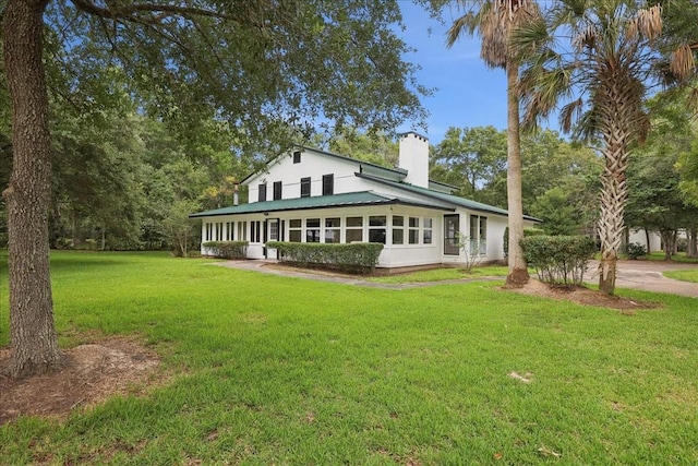 3533 Fm 563, Anahuac, TX 77514 - rear view of property with a chimney, a yard, and a metal roof