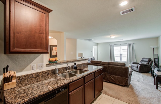 22418 Threefold Ridge Dr, Hockley, TX 77447 - kitchen featuring light colored carpet, dark stone counters, a peninsula, dishwasher, and open floor plan