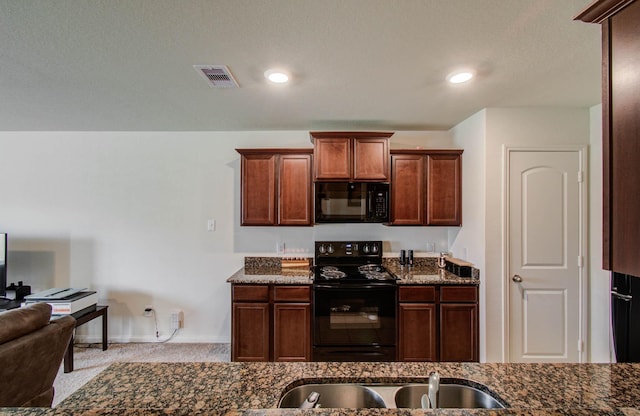 22418 Threefold Ridge Dr, Hockley, TX 77447 - kitchen featuring black appliances, dark stone countertops, and carpet flooring